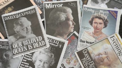 Newspapers devoted to the death of Queen Elizabeth II are seen in Manchester, England