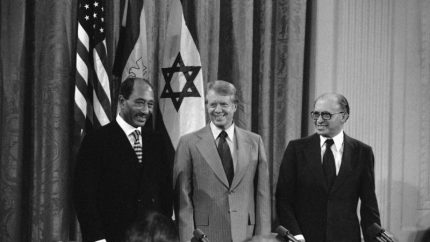 Egyptian President Anwar Sadat, U.S. President Jimmy Carter and Israeli Prime Minister Menachen Begin gather to sign the Camp David Accords