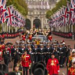 The coffin of Queen Elizabeth II is pulled past Buckingham Palace following her funeral service