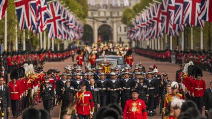 The coffin of Queen Elizabeth II is pulled past Buckingham Palace following her funeral service