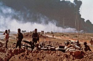  Iraqi soldiers wait by a well-hidden tank between Khorramshahr and Abadan while pipelines from the Iranian refinery burn in the background