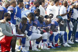 Buffalo Bills players take a knee during the playing of the national anthem