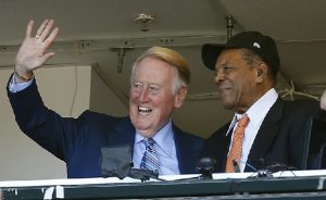 Los Angeles Dodgers announcer Vin Scully waves to fans alongside Hall of Famer baseball player Willie Mays (AP Photo-Tony Avelar)