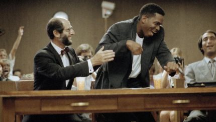 Live Crew leader Luther Campbell jumps from the defense table after a not guilty verdict was returned in the obscenity trial in Fort Lauderdale (AP Photo-Bill Cooke)