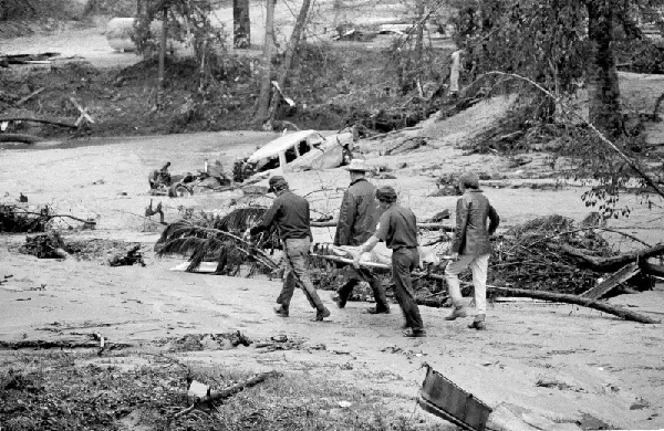 Rescue workers remove a body from the flooding waters near the Toccoa Falls Bible College (AP Photo)