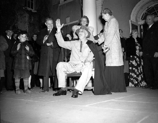 President Franklin Roosevelt waves a hearty greeting to neighbors who ended a torchlight parade on election night at his home in Hyde Park (AP Photo)