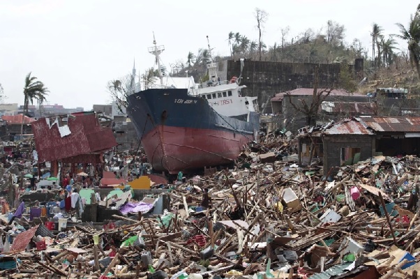 A ship lies on top of damaged homes after it was washed ashore in Tacloban city, Leyte province, central Philippines (AP Photo-Aaron Favila)