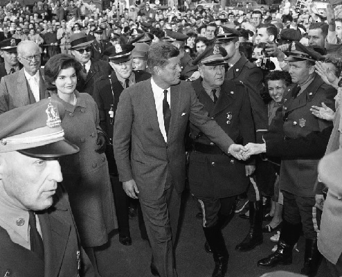 President-elect John F Kennedy gets a congratulatory handshake as he arrives at the Hyannis Armory (AP Photo)