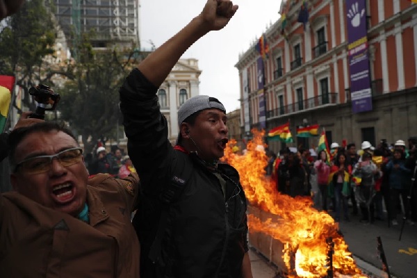 Opponents of Bolivia’s President Evo Morales celebrate after he announced his resignation in La Paz, Bolivia (AP Photo-Juan Karita)