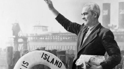 Arne Petterson, the last alien to leave Ellis Island before its closing, waves from the ferry boat Ellis Island (AP Photo)