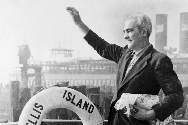 Arne Petterson, the last alien to leave Ellis Island before its closing, waves from the ferry boat Ellis Island (AP Photo)