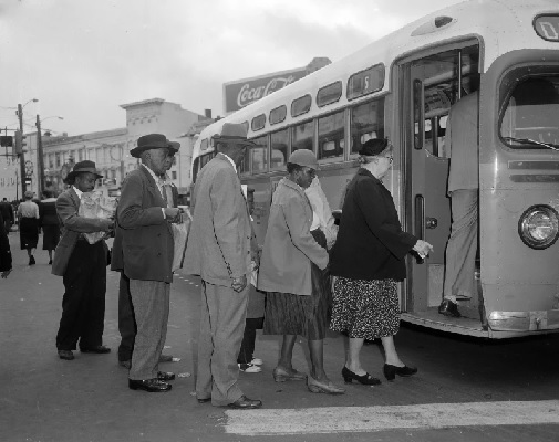  Black and white passengers board a city bus in Montgomery, Alabama as the Supreme Court’s order to stop segregation goes into effect (AP Photo-Harold Valentine)