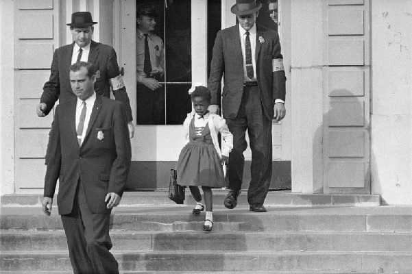 U S Deputy Marshals escort 6-year-old Ruby Bridges from William Frantz Elementary School in New Orleans (AP Photo-File)