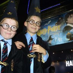 Harry Potter fans arrive at a London cinema for a showing of the first Harry Potter film on the day of its general release (AP Photo-Alastair Grant)