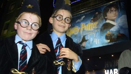 Harry Potter fans arrive at a London cinema for a showing of the first Harry Potter film on the day of its general release (AP Photo-Alastair Grant)