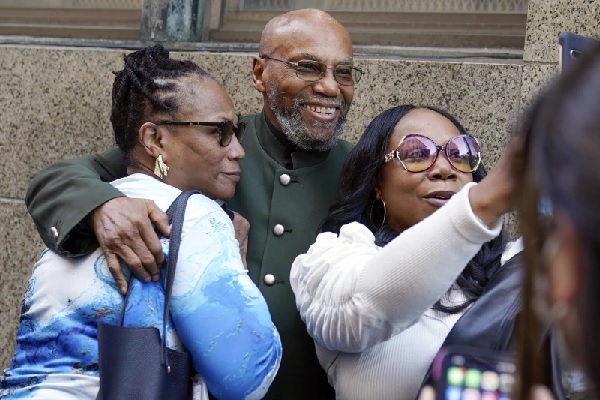 Muhammad Aziz stands outside the courthouse with members of his family after his conviction in the killing of Malcolm X was vacated (AP Photo-Seth Wenig, File)