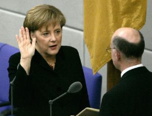 Newly appointed German chancellor Angela Merkel takes the oath of office in the parliament in Berlin. (AP Photo, Jockel Finck)