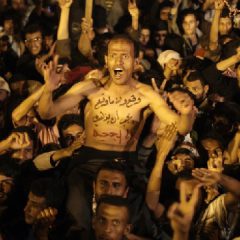 A protestor celebrates with others for the signing by Yemeni President Ali Abdullah Saleh of a document agreeing to step down (AP Photo-Hani Mohammed)