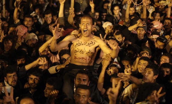 A protestor celebrates with others for the signing by Yemeni President Ali Abdullah Saleh of a document agreeing to step down (AP Photo-Hani Mohammed)