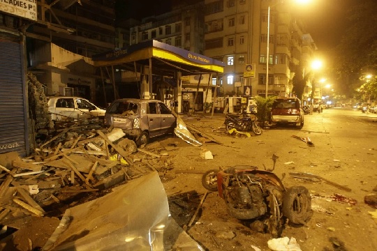 Debris lies scattered in the street at the site of a blast in Colaba, a market in downtown Mumbai, India (AP Photo-Gautam Singh)