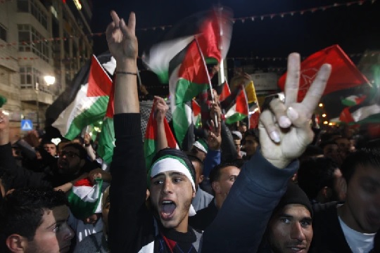 Palestinians celebrate as the UN General Assembly votes on a resolution to upgrade the status of the Palestinian Authority to a nonmember observer state (AP Photo)