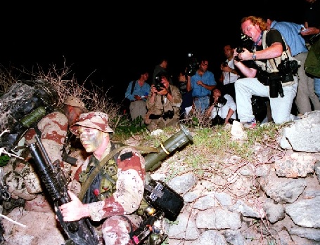 US Marines in a dug out hole surrounded by media as they arrive in Somalia during Operation Restore Hope (AP Photo - Robert Borea)