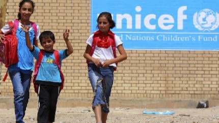 In September, 2013, Syrian refugee children receive items for school from UNICEF at a refugees camp in Iraq (AP Photo - Ceerwan Aziz