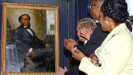 A painting of Joseph H Rainey, the first black person elected to Congress, is unveiled on Capitol Hill in 2005 (AP Photo - Dennis Cook)