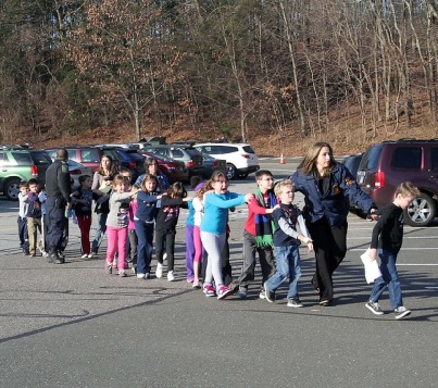 Children were told to close their eyes as they were guided to safety from the school building (uncredited)