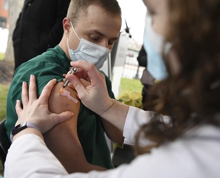 Colleen Teevan administers a vaccine for COVID-19 to Connor Paleski outside of Hartford Hospital (AP Photo-Jessica Hill)